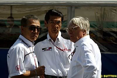 Bernie Takeo Bernie Ecclestone (right) with Takeo Fuki (left) and a Honda official