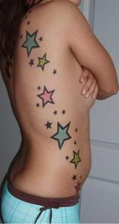 Tattoo on girl's side with multi-colored stars.